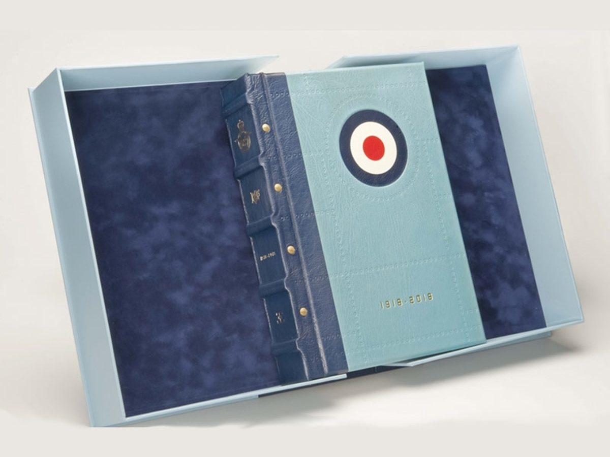 RAF centenary album in navy and sky-blue leather with a roundel and raised cords, in its presentation box